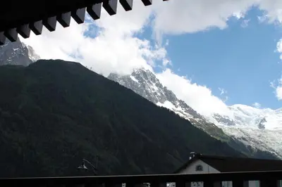 a view of a snow covered mountain with a house at Apartment Mummery 1 - Central Chamonix Walk to Piste in Chamonix-Mont-Blanc