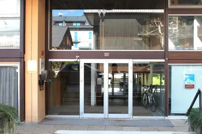 an open door to a building with a bike in it at Apartment Mummery 1 - Central Chamonix Walk to Piste in Chamonix-Mont-Blanc