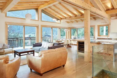 a living room with a couch and a table at Marmotte Mountain Eco Lodge in Chamonix-Mont-Blanc