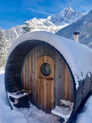 a wooden barn with snow on top of it at Marmotte Mountain Eco Lodge in Chamonix-Mont-Blanc