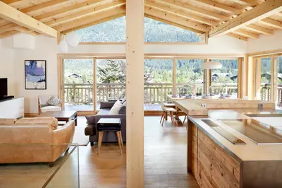 a kitchen and living room with a large window at Marmotte Mountain Eco Lodge in Chamonix-Mont-Blanc