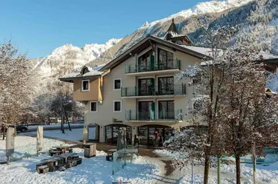 a building in the mountains with snow on the ground at Ginabelle 8 apartment - Chamonix All Year in Chamonix-Mont-Blanc