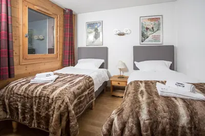 a hotel room with two beds and a window at Ginabelle 8 apartment - Chamonix All Year in Chamonix-Mont-Blanc