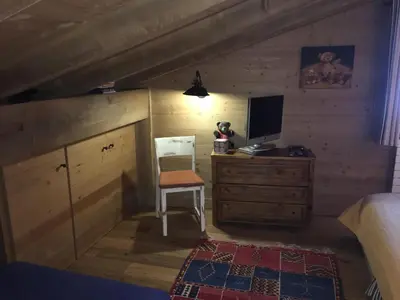 a bedroom with a bed and a desk with a computer at Chalet Mine de rien in Megève