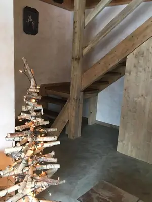a christmas tree made out of logs in a room at Les Chalets Aquarelle in Chamonix-Mont-Blanc