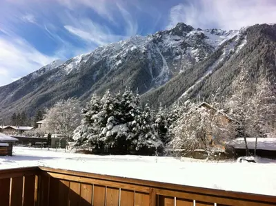 a view of a snow covered mountain from a house at Les Chalets Aquarelle in Chamonix-Mont-Blanc
