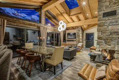 a dining room with a stone fireplace and a table and chairs at Peace and Love in Chamonix-Mont-Blanc