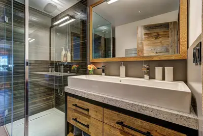 a bathroom with a white sink and a shower at Peace and Love in Chamonix-Mont-Blanc