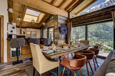 a dining room and kitchen with a table and chairs at Peace and Love in Chamonix-Mont-Blanc