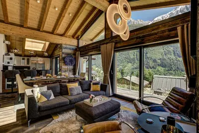 a living room filled with furniture and a large window at Peace and Love in Chamonix-Mont-Blanc