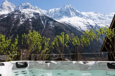 a bath tub with a view of snow covered mountains at Peace and Love in Chamonix-Mont-Blanc