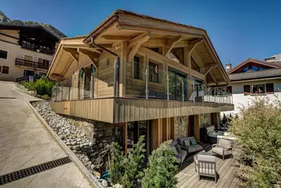 a large wooden house with a porch and a deck at Peace and Love in Chamonix-Mont-Blanc