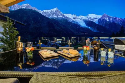 a room with a table with a view of mountains at Peace and Love in Chamonix-Mont-Blanc