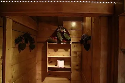 a room with wooden walls and a shelf with shoes at Chalet Alpine Rose in Chamonix-Mont-Blanc