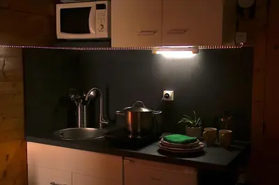 a kitchen with a sink and a pot on a counter at Chalet Alpine Rose in Chamonix-Mont-Blanc