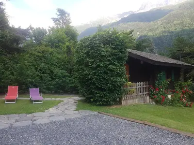 two chairs sitting in front of a house at Chalet Alpine Rose in Chamonix-Mont-Blanc