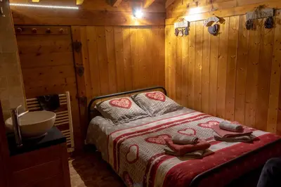 a bedroom with a bed in a log cabin at Chalet Alpine Rose in Chamonix-Mont-Blanc