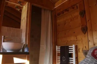 a bathroom with a tub and a sink in a room at Chalet Alpine Rose in Chamonix-Mont-Blanc