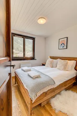 a bedroom with a large bed in a room at APARTMENT LES DRUS - Alpes Travel - Chamonix - Sleeps 6 in Chamonix-Mont-Blanc