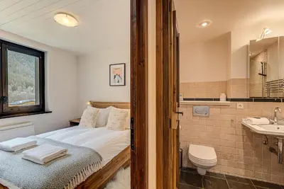 a bedroom with a bed and a sink and a toilet at APARTMENT LES DRUS - Alpes Travel - Chamonix - Sleeps 6 in Chamonix-Mont-Blanc