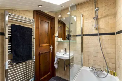 a bathroom with a tub and a sink and a shower at APARTMENT LES DRUS - Alpes Travel - Chamonix - Sleeps 6 in Chamonix-Mont-Blanc