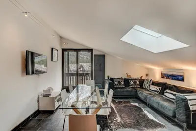 a living room with a couch and a table at APARTMENT LES DRUS - Alpes Travel - Chamonix - Sleeps 6 in Chamonix-Mont-Blanc
