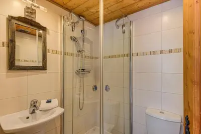 a bathroom with a shower and a sink and a toilet at APARTMENT CHAMOUNY - Alpes Travel - Chamonix - Sleeps 8 in Chamonix-Mont-Blanc