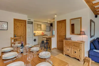 a dining room with a table with wine glasses on it at APARTMENT CHAMOUNY - Alpes Travel - Chamonix - Sleeps 8 in Chamonix-Mont-Blanc