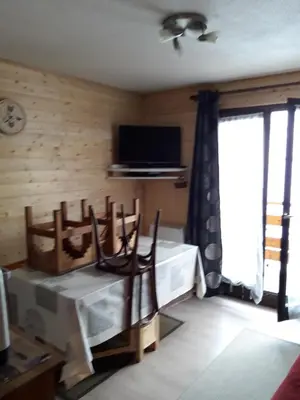 a bedroom with a bed and a tv and a window at appart st gervais le Topaze in Saint-Gervais-les-Bains