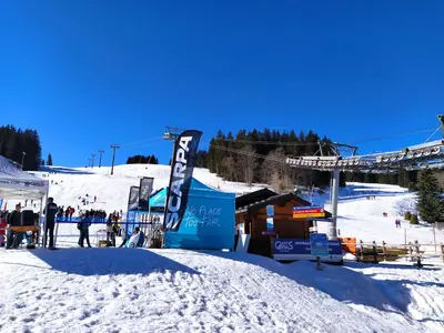 a snow covered ski slope with a ski lift at appart st gervais le Topaze in Saint-Gervais-les-Bains