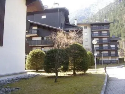a large building with a tree in front of it at Apartment Clos du Savoy in Chamonix-Mont-Blanc