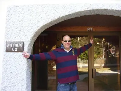 a man is standing in front of a door at Apartment Clos du Savoy in Chamonix-Mont-Blanc
