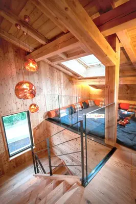 a room with a spiral staircase in a cabin at Chalet spacieux à Samoëns de 210 m² avec jacuzzi et jardin in Samoëns