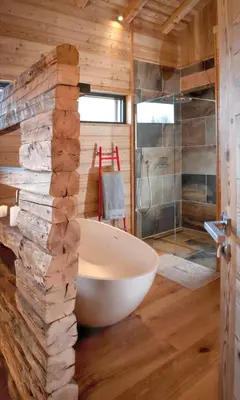 a bathroom with a large tub and a glass shower at Chalet spacieux à Samoëns de 210 m² avec jacuzzi et jardin in Samoëns