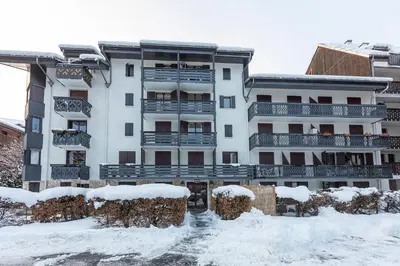 a building with snow in front of it at Studio Aoste in Chamonix-Mont-Blanc
