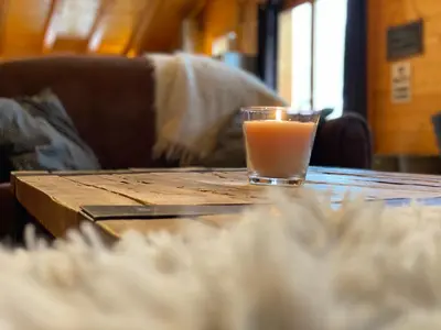 a candle sitting on a wooden table on a wooden table sidx sidx at Chalet 4C in Les Houches