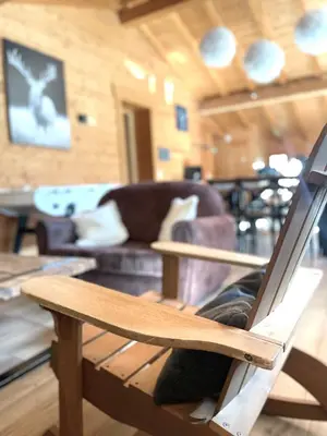 a person sitting on a bench in a living room at Chalet 4C in Les Houches