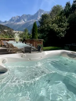 a hot tub with a view of mountains at Chalet 4C in Les Houches