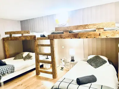 two bunk beds in a room with two white beds at Chalet 4C in Les Houches