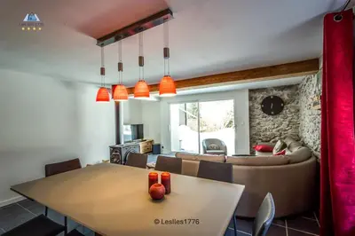 a living room with a table and a couch at Les Iles 1776 in Chamonix-Mont-Blanc