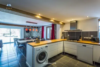 a kitchen with a washer and dryer in it at Les Iles 1776 in Chamonix-Mont-Blanc