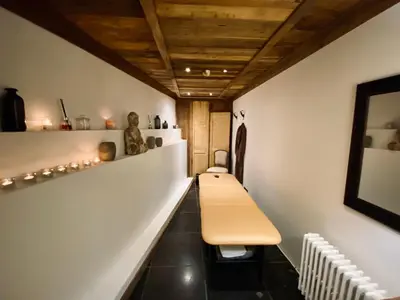 a hallway with a bench in a room at Le Chalet Blanc in Megève