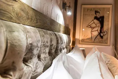 a close up of a bed with pillows on it at Le Chalet Blanc in Megève