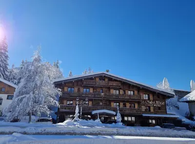 a lodge in the snow with a christmas tree at Le Chalet Blanc in Megève