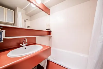 a bathroom with a sink and a bath tub at Eden Studio Chamonix Centre in Chamonix-Mont-Blanc