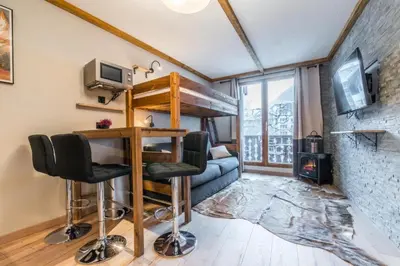 a living room with a couch and chairs in a room at Eden Studio Chamonix Centre in Chamonix-Mont-Blanc