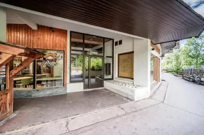 a store front with glass doors on a building at Eden Studio Chamonix Centre in Chamonix-Mont-Blanc