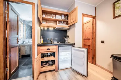a kitchen with a sink and a refrigerator at Eden Studio Chamonix Centre in Chamonix-Mont-Blanc