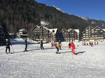 a group of people skiing in the snow at a lodge at Front Ski Slope Chamonix Apartment in Chamonix-Mont-Blanc