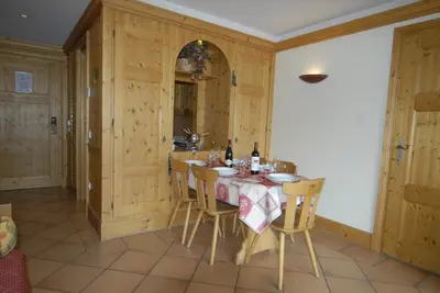 a kitchen with a table and chairs in a room at Front Ski Slope Chamonix Apartment in Chamonix-Mont-Blanc